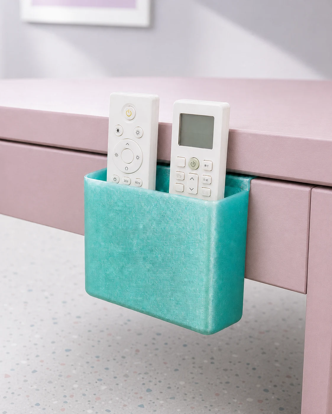 淡いテラゾー床の部屋で、天板と脚部フレームの間にリモコンポケットを取り付けたイメージ